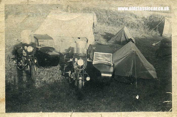A pair of sidecars parked near some tents