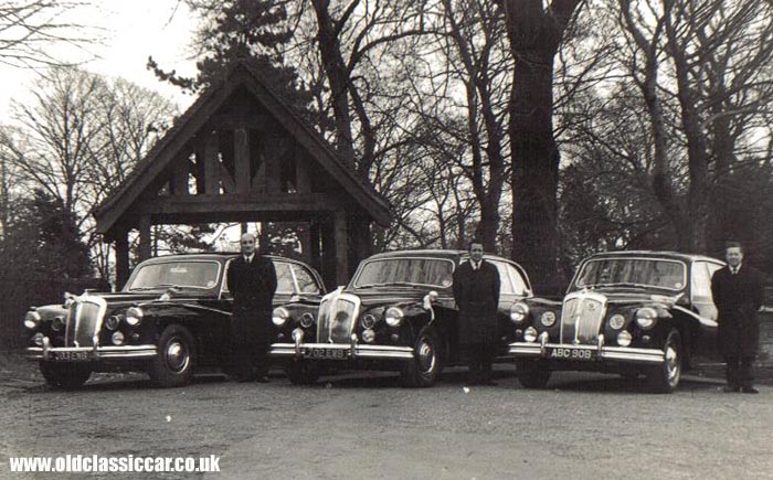 Three Daimlers at a church