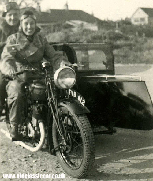 A couple sat on their motorcycle/sidecar combination